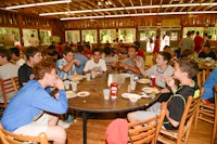 Boys at summer camp in dining hall eating.jpg?ixlib=rails 2.1