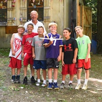 Young boys at summer camp with counselor holding airplane.jpg?ixlib=rails 2.1