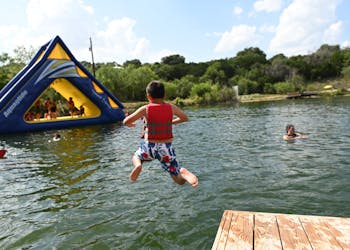 Boy leaping into the lake.jpg?ixlib=rails 2.1