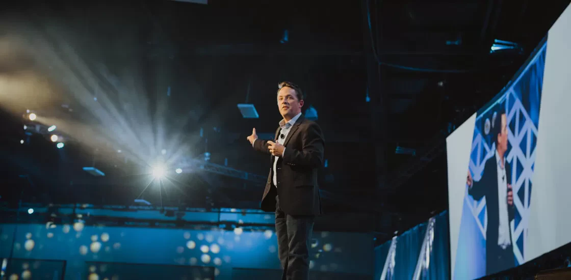 Daniel Coyle speaking onstage