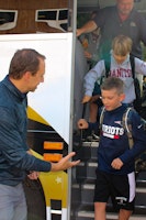 Director jon greets kids off the bus.jpg?ixlib=rails 2.1