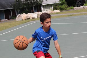 Boy playing basketball at summer camp.jpg?ixlib=rails 2.1
