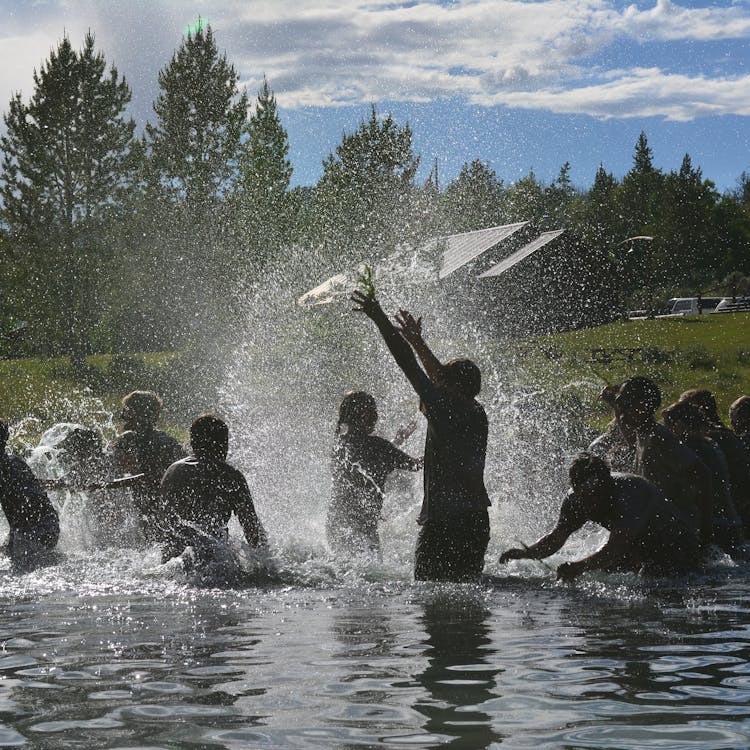 Western summer camp boys splashing in pond.jpg?ixlib=rails 2.1