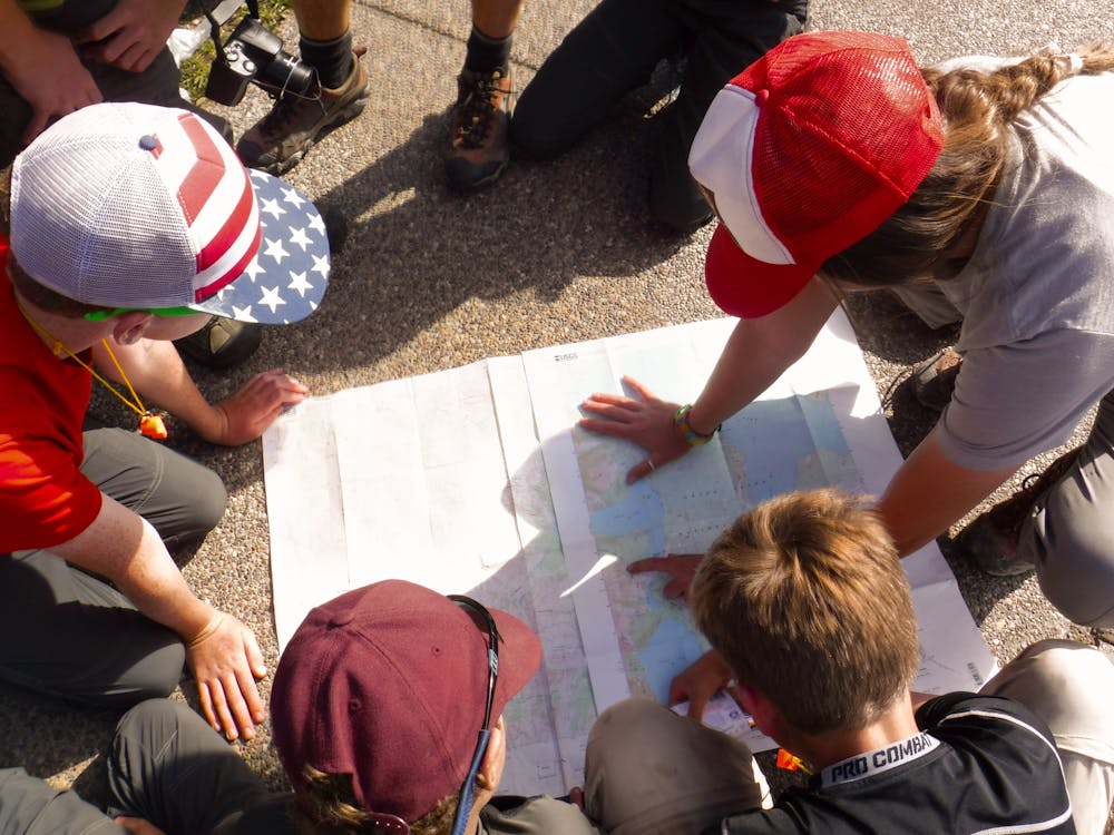 Staff and campers study a map.jpg?ixlib=rails 2.1