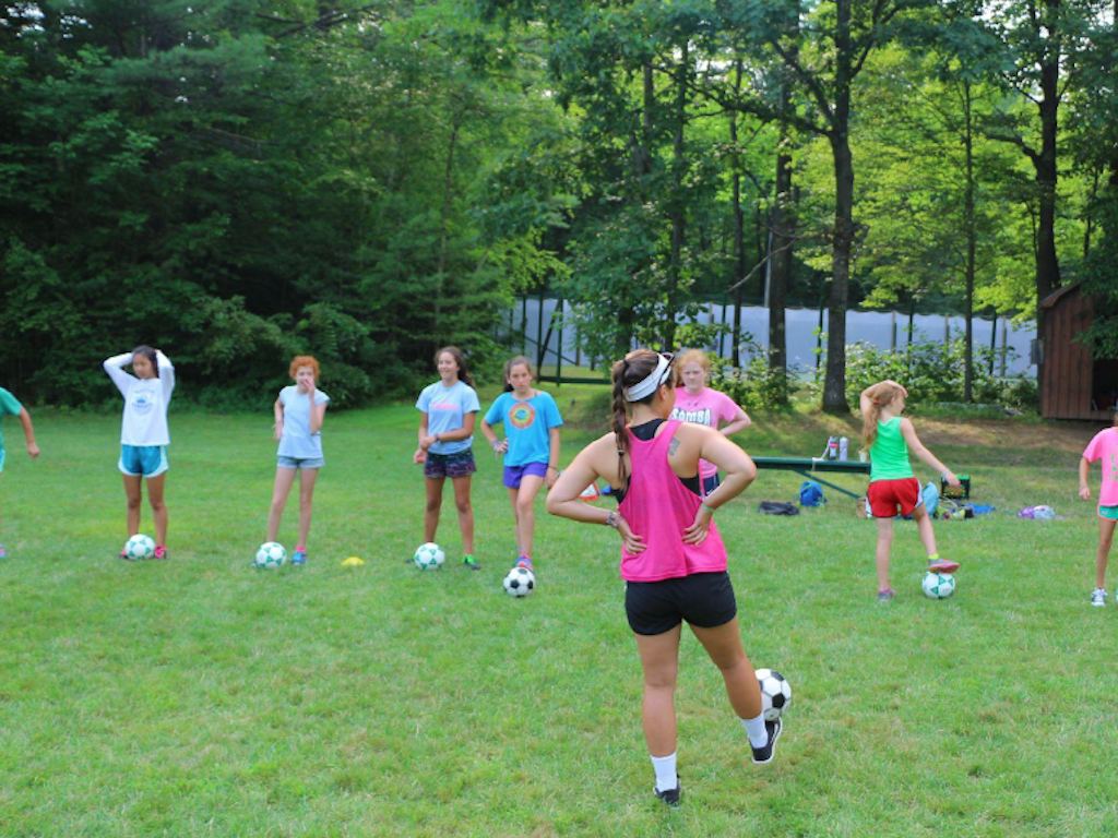 What makes playing sports at camp different from playing sports at school?