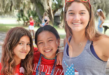 Three smiling girl campers