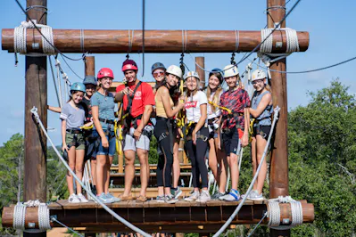 A group photo of campers on a high ropes platform