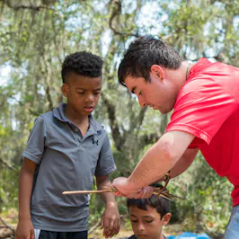 Counselor working with two boys