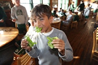 Boys camp dining room eating lettuce.jpg?ixlib=rails 2.1