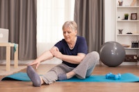 Active old woman exercising yoga mat her comfortable apartment.jpeg?ixlib=rails 2.1