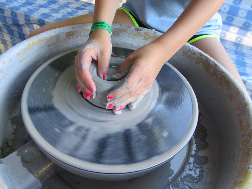 Spinning clay on the pottery wheel.jpg?ixlib=rails 2.1