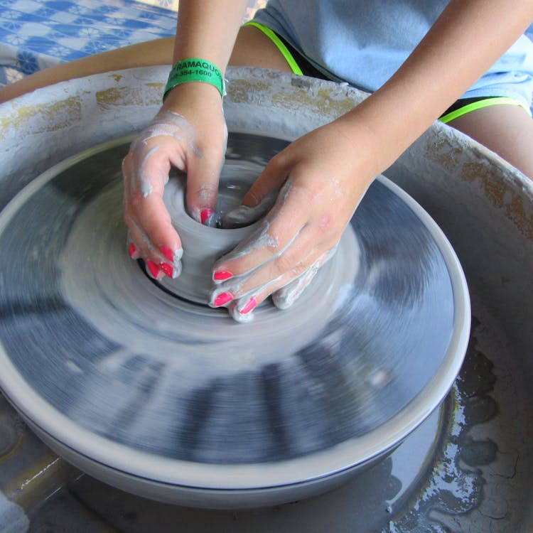 Spinning clay on the pottery wheel.jpg?ixlib=rails 2.1