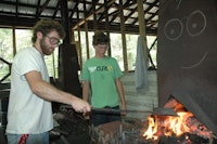 Teaching blacksmithing to kids at camp.jpg?ixlib=rails 2.1