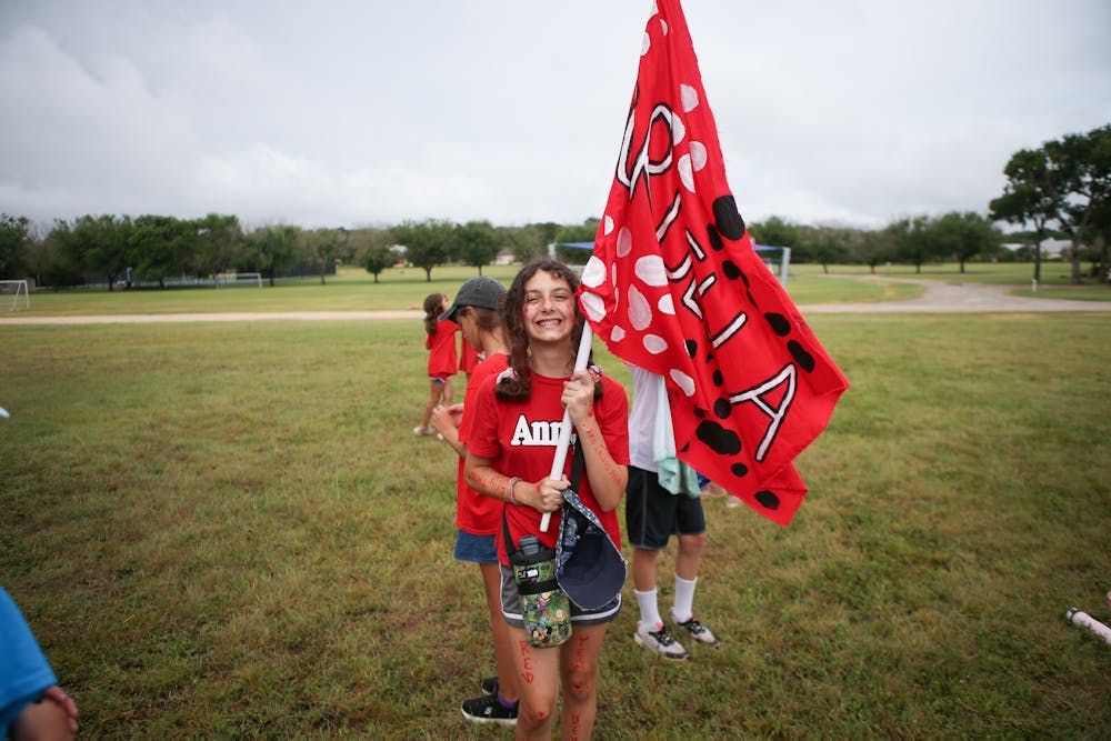 Texas summer camp girl holding flag.jpg?ixlib=rails 2.1